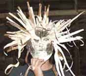 Person holding a birchbark mask.