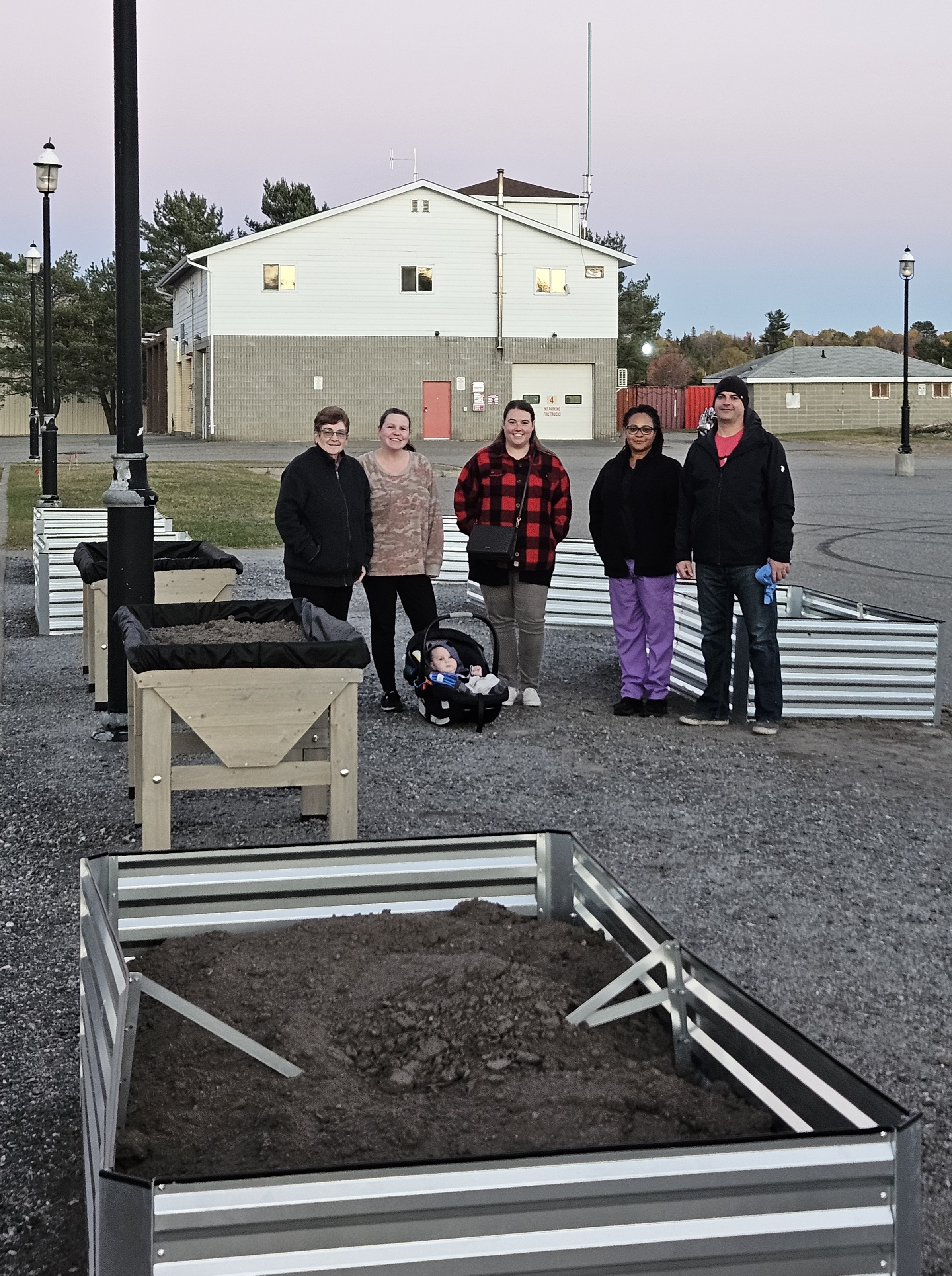 Photo of garden beds and members of Community Action Network