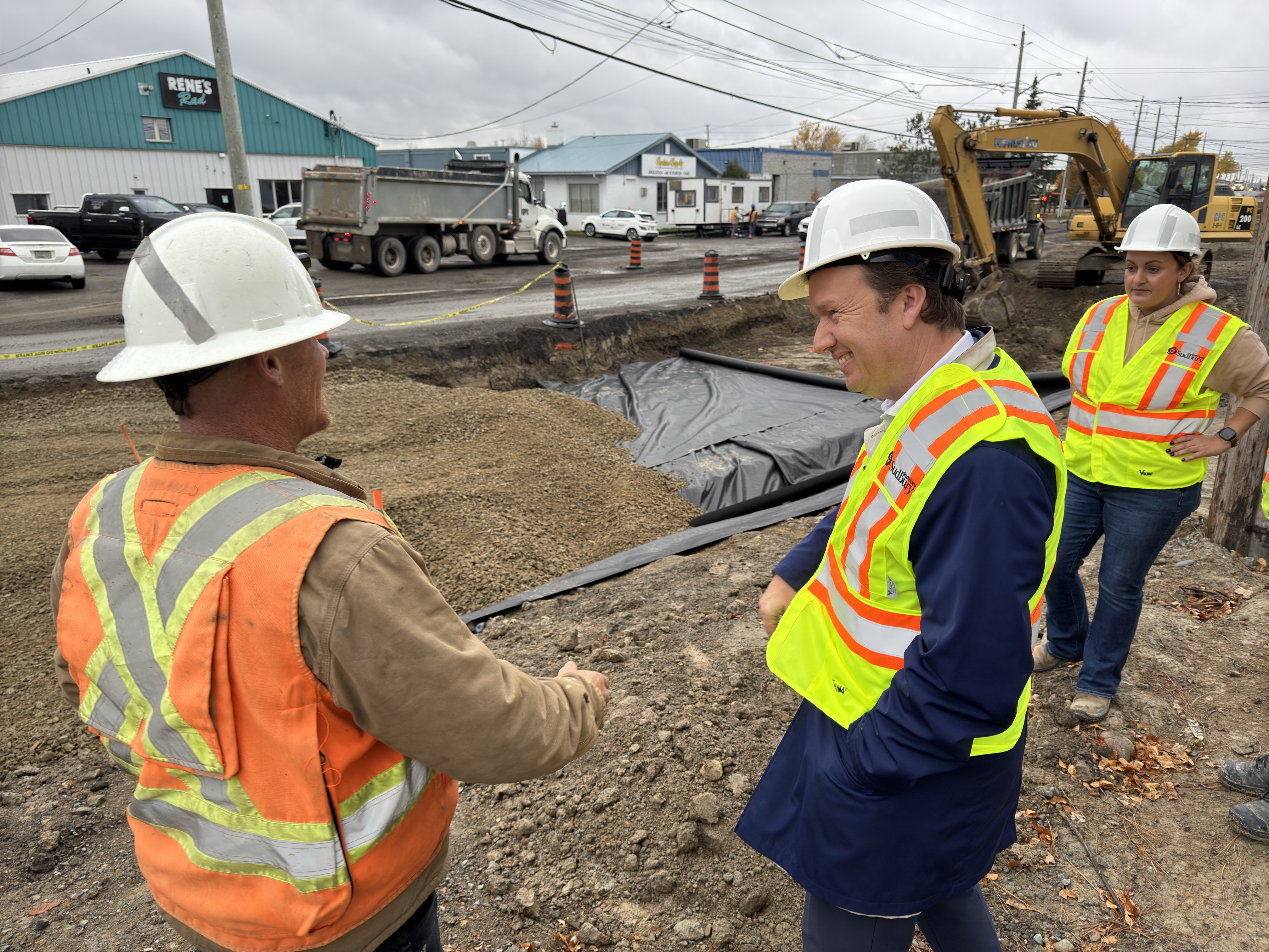 Mayor Paul Lefebvre visiting a busy road construction site.