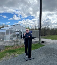 Councillor Sizer standing in front of Twin Forks Greenhouse