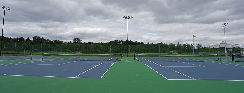 Four empty tennis courts.