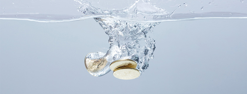 Coins falling into water.