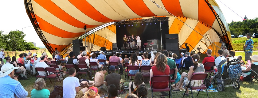 An outdoor concert under a tent.