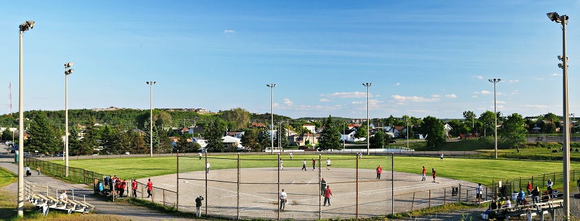 People playing baseball on a baseball field.