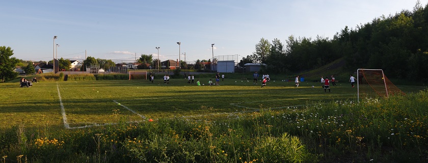 Two soccer teams playing a soccer game on a field