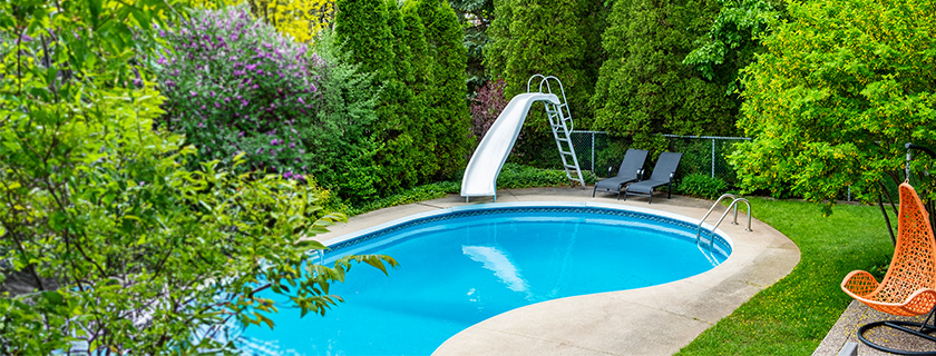 An outdoor pool with a waterslide.