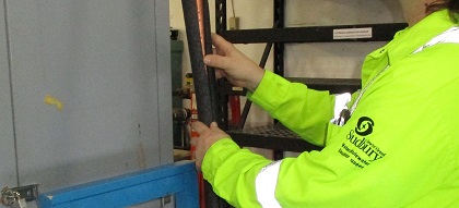 Insulation being applied over pipe.